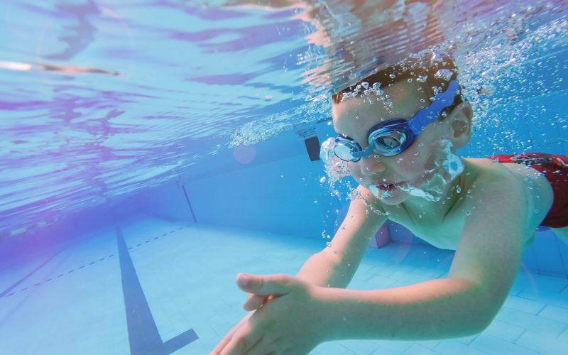 Underwater,Young,Boy,Fun,In,The,Swimming,Pool,With,Goggles.